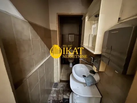 Smaller bathroom with a washbasin and a toilet further down. - image 6