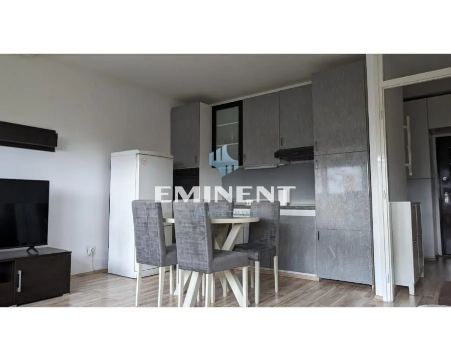 Kitchen with a dining area and grey kitchen units.