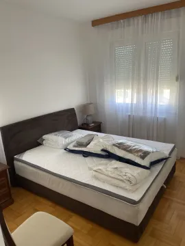 Bright bedroom with a double bed and parquet floor. - image 9