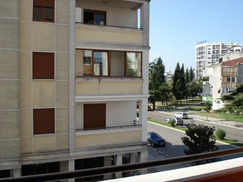 View from the terrace showing the neighboring building's facade and the street. - image 11