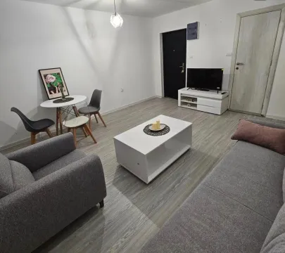 Living room furnished with a sofa set, coffee table, and dining table. - image 2