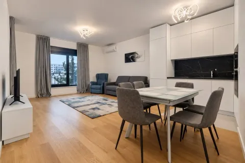 Modern living room with dining area and built-in kitchen. - image 3
