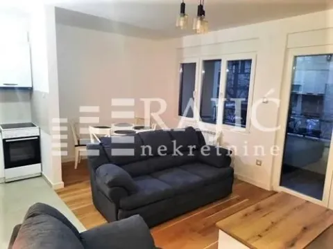 Living room with sofa and dining area. - image 2