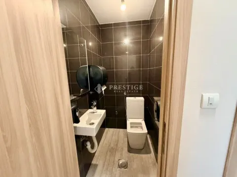 Small bathroom with dark tiles, washbasin and toilet. - image 8