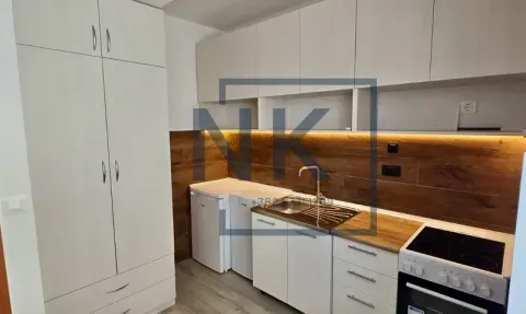 Small kitchen with white cabinets, sink, and built-in stove. - image 4