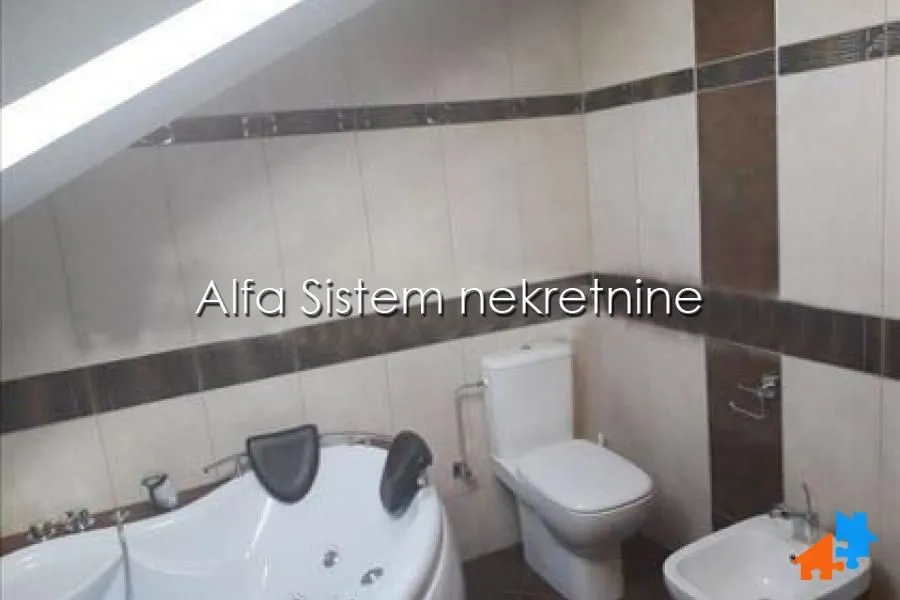 Bathroom equipped with a bathtub, toilet, and bidet.
