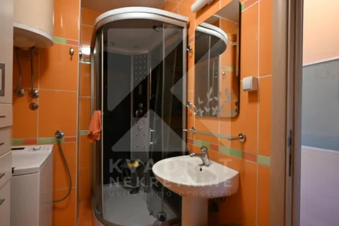 Bathroom with a shower cabin and washbasin. - image 20