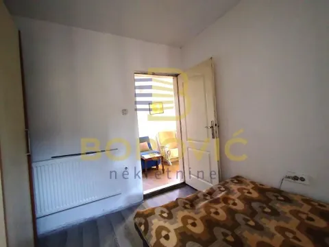 Small bedroom with a bed and a radiator. - image 6