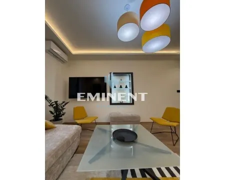 Living room with sofa, coffee table and modern lighting. - image 3