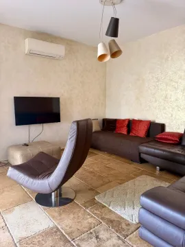 Living room with sofa set, armchair, TV, and air conditioning. - image 7
