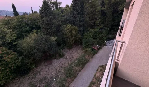 View from the terrace overlooking the courtyard and surrounding greenery. - image 8