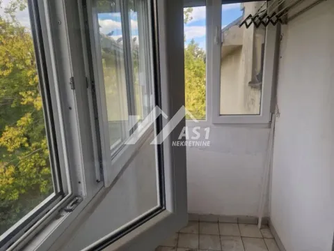 View of an open balcony with windows and greenery in the background. - image 12