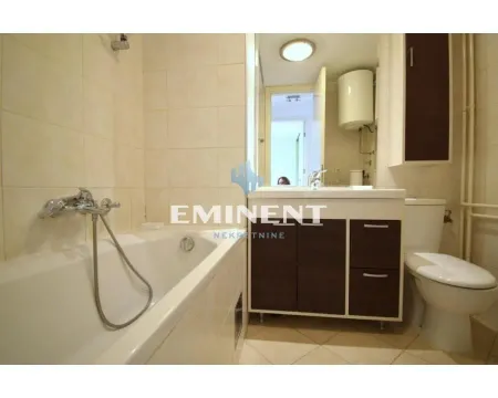 Bathroom equipped with a bathtub, washbasin, and toilet. - image 17