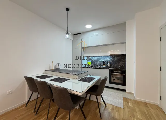 Modern kitchen with a dining table and built-in appliances.