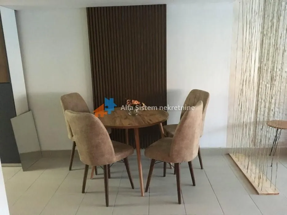 Dining area with a round table and four chairs.