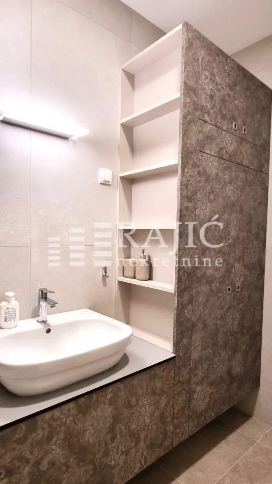 Modern bathroom with a sink and built-in cabinetry.