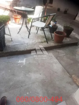 Small paved courtyard with seating furniture and flower pots. - image 7