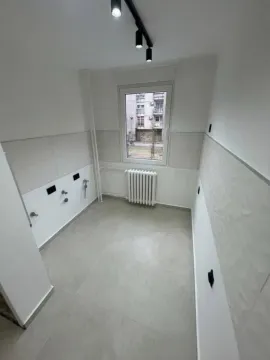 Prazna kuhinja sa pločicama, prozorom i radijatorom. - image 12