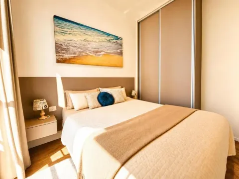 Furnished bedroom with a double bed, wardrobe, and a wall painting. - image 6