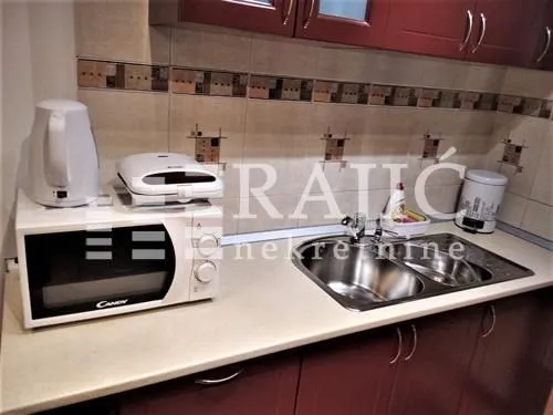 Part of the kitchen with a countertop, sink, and home appliances.