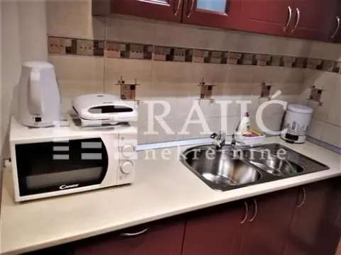 Part of the kitchen with a countertop, sink, and home appliances. - image 7