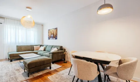 Living room with sofa, dining table and chairs. - image 2