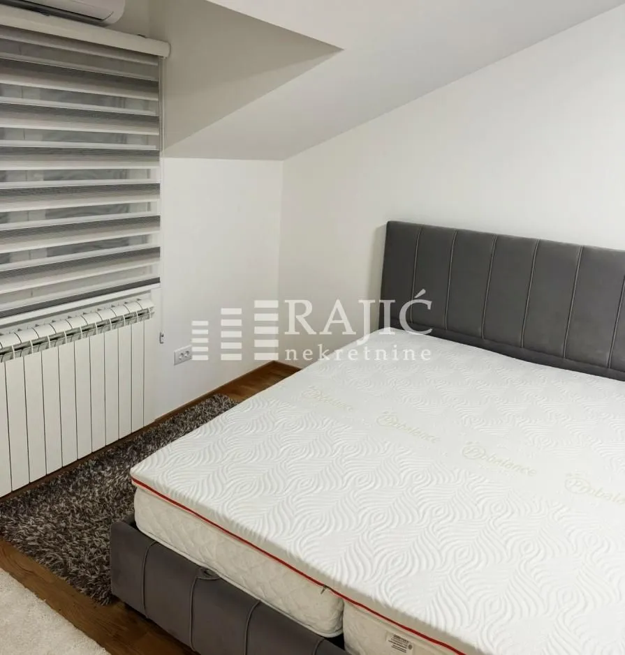 Bedroom with a double bed and sloping ceiling.