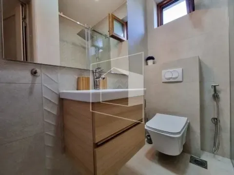 Modernly equipped bathroom with a washbasin, toilet, and shower cabin. - image 12