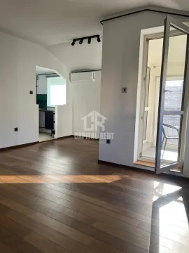Empty living room with wooden flooring and access to the balcony. - image 12