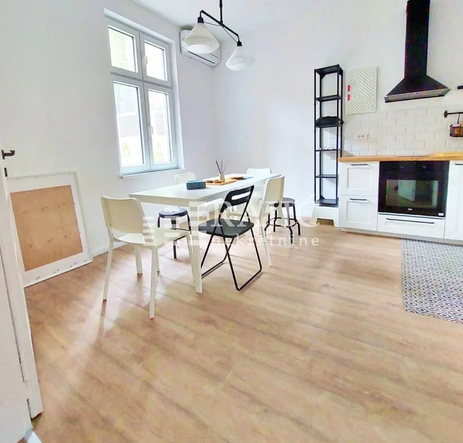 Bright kitchen with a dining area and modern furniture.