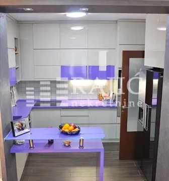 Modern kitchen with light cabinetry and purple details. - image 10