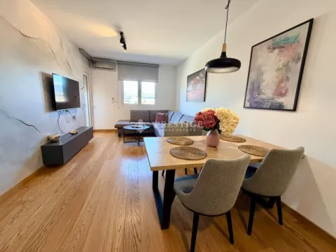 Living room with dining area and modern furniture. - image 2