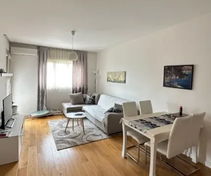 Living room with sofa set, dining table and hardwood flooring. - image 2