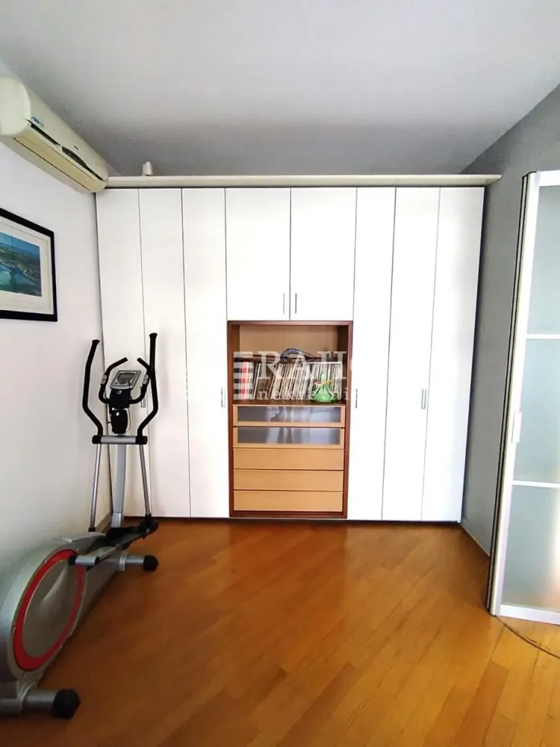 Bedroom with a large fitted wardrobe and an exercise machine.