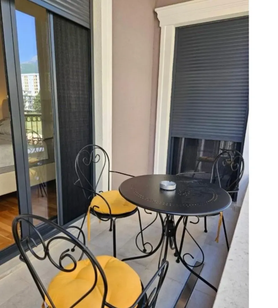 Furnished balcony with a table and chairs.