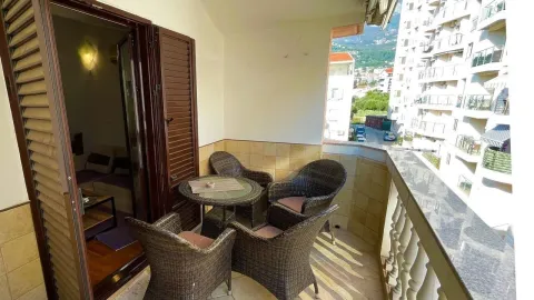 Covered terrace with seating furniture and a view of the neighborhood. - image 8