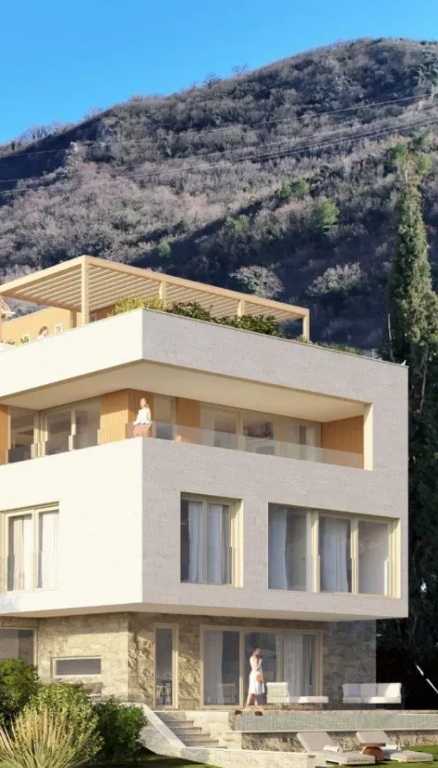 Spoljašnji izgled moderne stambene zgrade sa terasama i dvorištem.