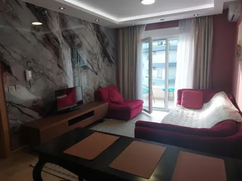 Living room with a sofa, TV, and access to the terrace. - image 8