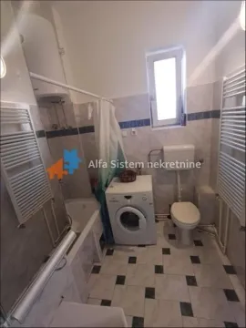 Bathroom equipped with sanitary fixtures, bathtub, and washing machine. - image 20