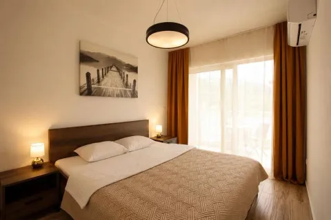 Furnished bedroom with a double bed, nightstands, and access to the terrace. - image 10