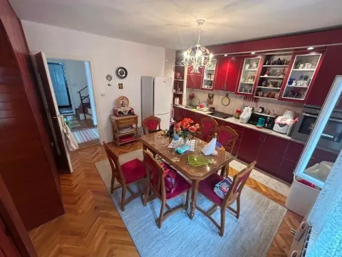 Kitchen with dining area and red kitchen cabinets. - image 5
