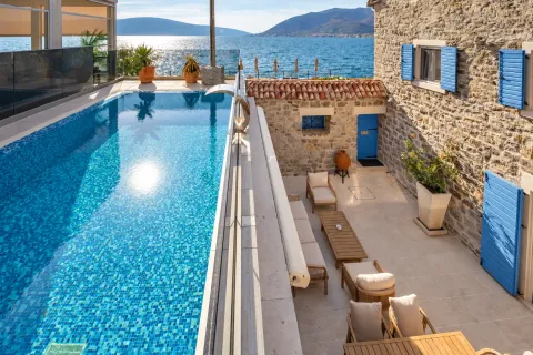 Terrace with a swimming pool and outdoor seating area with a sea view. - image 13