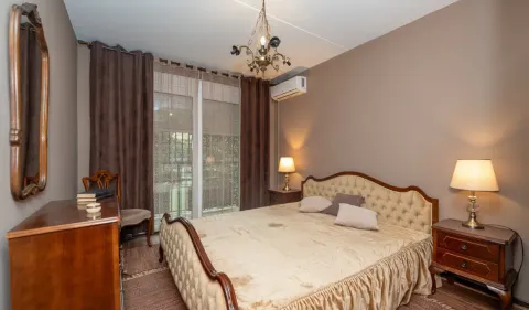 Furnished bedroom with a double bed, bedside tables, and a dresser. - image 8