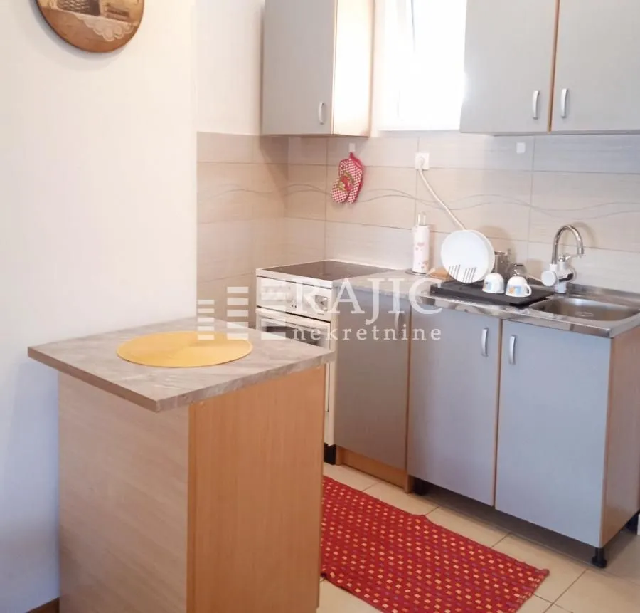 Smaller kitchen with cabinets and a dining area.