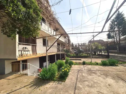 Yard and exterior of a two-story house with plants. - image 3