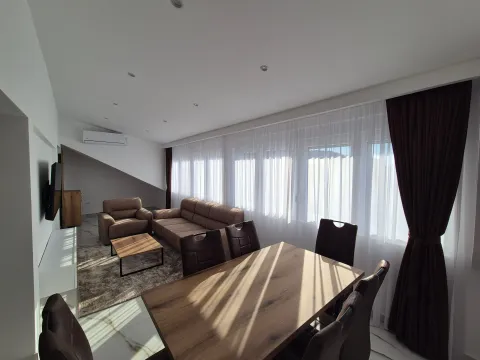 Living room with a sofa set, dining table and large windows. - image 2
