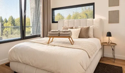 Bright and neat bedroom with a double bed and a large window. - image 10