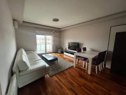 Living room with a sofa, dining table, and access to the terrace. - image 2