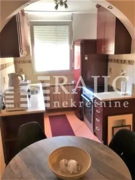 Smaller kitchen with a dining table and window. - image 5
