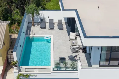 Aerial view of a spacious terrace with a swimming pool and sun loungers. - image 5